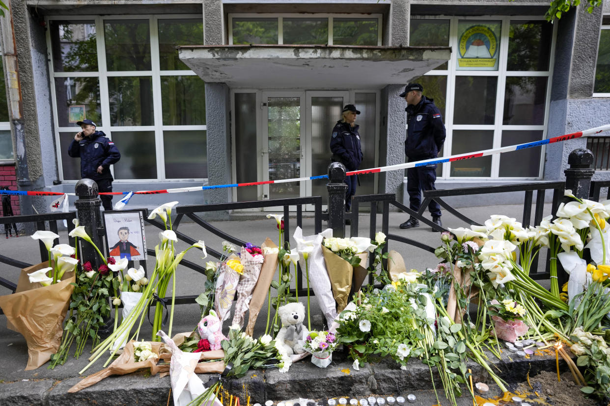 Police officers guard the Vladimir Ribnikar school in Belgrade, Serbia, Thursday, May 4, 2023. A 13-year-old who opened fire Wednesday at his school in Serbia's capital killed eight fellow students and a guard before calling the police and being arrested. Six children and a teacher were also hospitalized. (AP Photo/Darko Vojinovic)