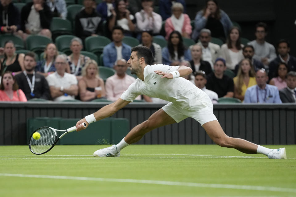 Serbia's Novak Djokovic returns to Poland's Hubert Hurkacz in a men's singles match on day seven of the Wimbledon tennis championships in London, Sunday, July 9, 2023. (AP Photo/Kirsty Wigglesworth)