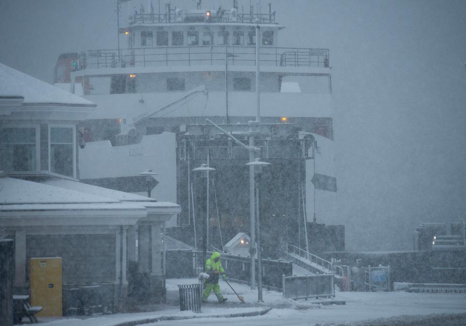 The Steamship Authority ferry Eagle rides out the storm in her slip at the Hyannis terminal as crews get busy with snow removal as the storm picked up mid-day Tuesday.