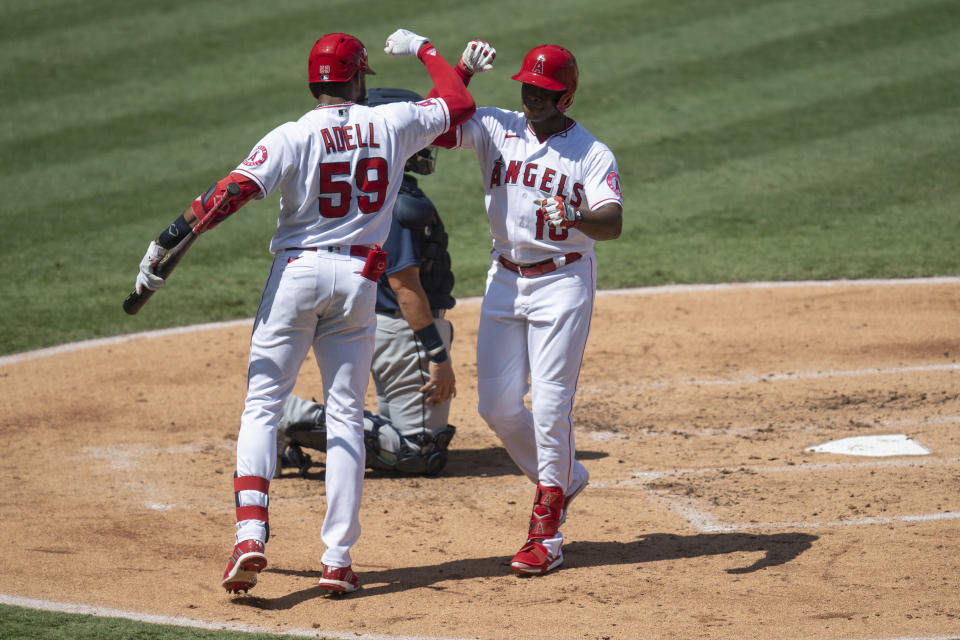 Los Angeles Angels' Justin Upton, right, celebrates his solo home run with Jo Adell in the second inning of a baseball game against the Seattle Mariners in Anaheim, Calif., Monday, Aug. 31, 2020. (AP Photo/Kyusung Gong)