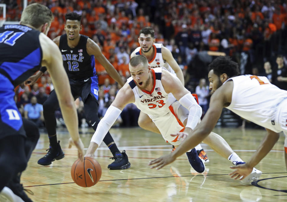 Virginia center Jack Salt (33) dives for a loose ball during the first half of the team's NCAA college basketball game against Duke on Saturday, Feb. 9, 2018, in Charlottesville, Va. (AP Photo/Zack Wajsgras)