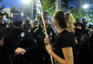 Police officers move forward to clear the street during a protest over the Monday death of George Floyd, a handcuffed black man in police custody in Minneapolis, in downtown Los Angeles, Friday, May 29, 2020. (AP Photo/Ringo H.W. Chiu)