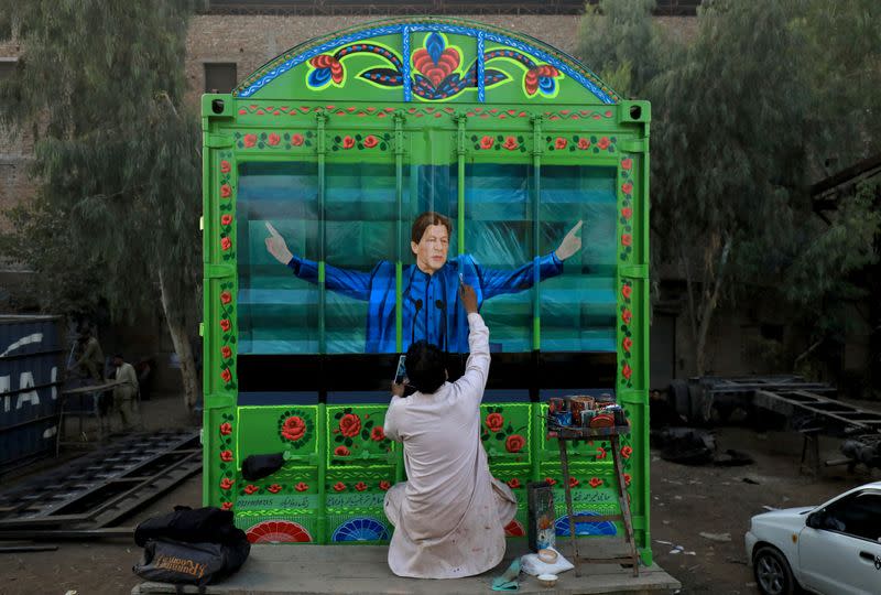 Sohail Ghuri paints a portrait of former Pakistan PM Khan on wooden planks of a truck at a workshop in Peshawar