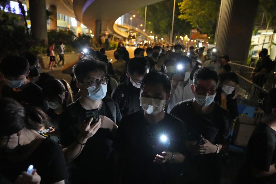 FILE - In this June 4, 2021, file photo, people hold LED candles to mark the anniversary of the military crackdown on a pro-democracy student movement in Beijing, outside Victoria Park in Hong Kong. The group behind the annual Tiananmen Square memorial rally in Hong Kong said Sunday, Sept. 5, it will not cooperate with police conducting a national security investigation into the group's activities, calling it an abuse of power. (AP Photo/Kin Cheung, File)