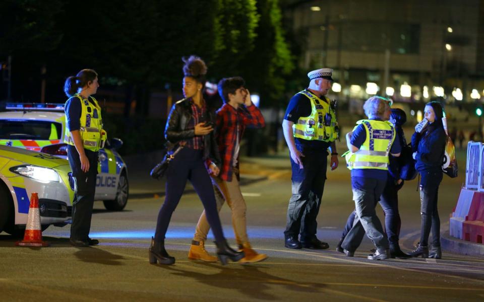 Police and fans outside the Manchester Arena following the explosion - Credit: Getty Images