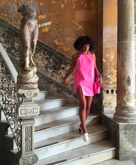 Solange descends a gorgeous staircase in Havana. 