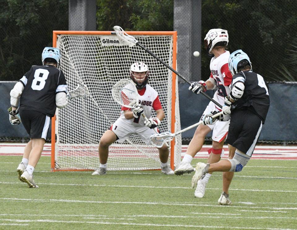 Oxbridge Academy's Parker Fite holds steady in goal, ready to react to the shot from the Eagles' Charlie Bublitz. Bublitz led St. John Paul II with two goals on the night on April 14, 2022.