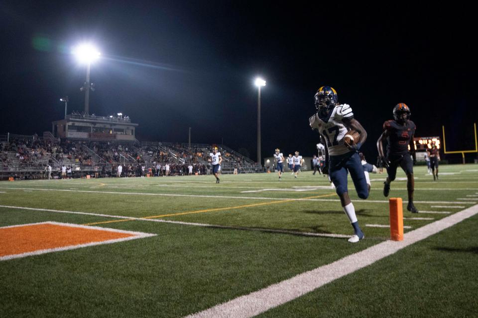 Naples' Stanley Bryant (17) scores a touchdown during the 48th Coconut Bowl between Naples and Lely, Friday, Oct. 15, 2021, at Lely High School in Naples, Fla.Naples defeated Lely 52-9.