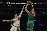 Boston Celtics' Jayson Tatum (0) makes a 3-point basket over Los Angeles Lakers' Danny Green (14) during the first half of an NBA basketball game Sunday, Feb. 23, 2020, in Los Angeles. (AP Photo/Marcio Jose Sanchez)