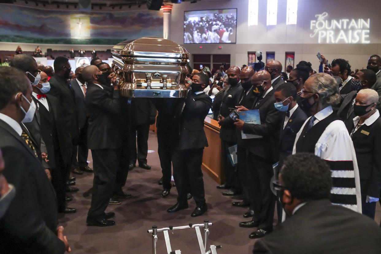 HOUSTON, TX - JUNE 09:   Pallbearers recess out of the church with the casket following the funeral for George Floyd at The Fountain of Praise church on June 9, 2020 in Houston, Texas. Floyd died after being restrained by Minneapolis Police officers on May 25, sparking global protests. (Photo by Godofredo A. Vásquez - Pool/Getty Images)