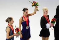 Alissa Czisny of the US (C) celebrates her gold medal victory ahead of Carolina Kostner of Italy (L) and Viktoria Helgesson of Sweden (R) on the ineers podium following the Ladies Free Skate competition at the Citizens Business Bank Arena in Ontario, California, on October 23 2011, during the 2011 ISU Grand Prix of Figure Skating competition. AFP PHOTO / Frederic J. BROWN (Photo credit should read FREDERIC J. BROWN/AFP/Getty Images)