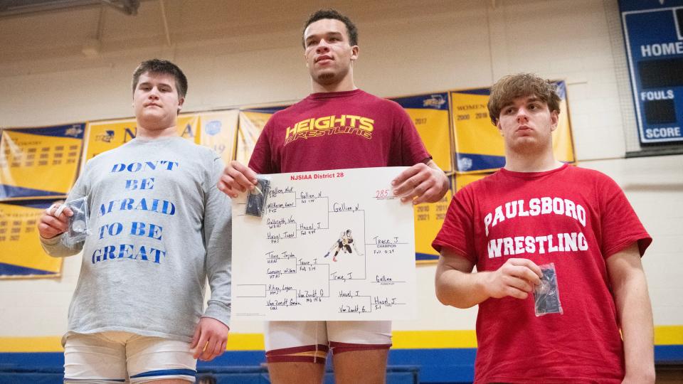 Haddon Heights' Jayden Trace, center, stands on top of the podium after pinning Sterling's Nick Gellien during the 285 lb. bout of the championship round of the District 28 wrestling tournament held at the Rowan College of South Jersey in Deptford on Saturday, February 17, 2024.