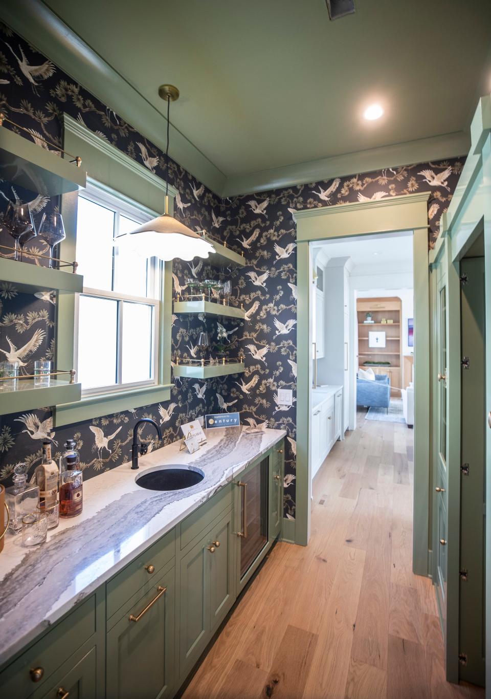 A pantry with a counter, sink, and bold wallpaper in a Daryl Hardy built Homearama house at The Hamlet in Norton Commons. Sept. 15, 2022