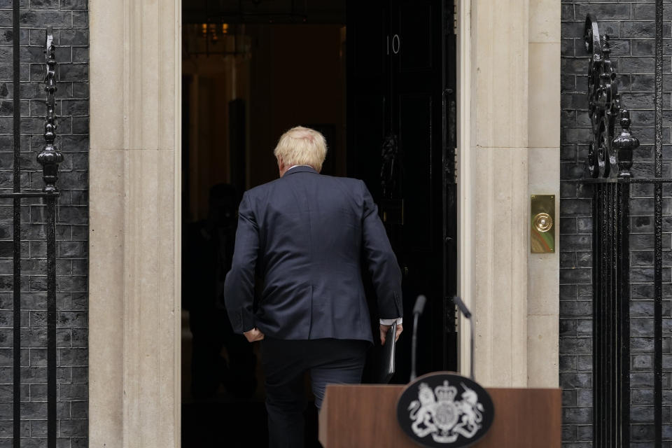 Prime Minister Boris Johnson enters 10 Downing Street, after reading a statement in London, Thursday, July 7, 2022. Boris Johnson has stepped down as Conservative Party leader, but the scandal-tarnished politician remains Britain’s prime minister — for now. Johnson’s resignation sparks a party contest to replace him as leader. All Conservative lawmakers are eligible to run, and party officials could open the nominations within hours. (AP Photo/Alberto Pezzali)