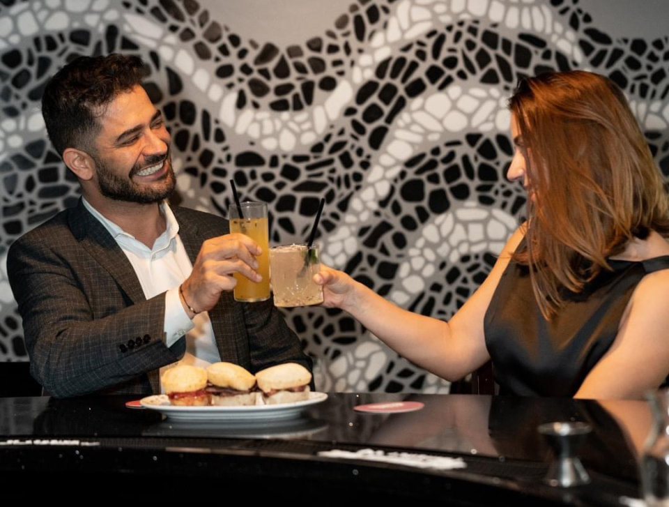 Wellington Brito, the founder of Leblon Steak, is pictured at the bar of his Hillside, New Jersey location with marketing manager, Aime Alvim.