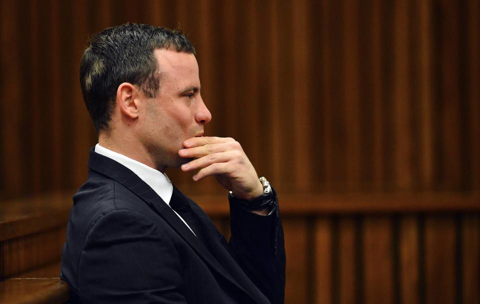 South African Olympic and Paralympic athlete Oscar Pistorius sits in the dock during his murder trial in the North Gauteng High Court in Pretoria June 30, 2014. Pistorius is on trial for murdering his girlfriend Reeva Steenkamp at his suburban Pretoria home on Valentine's Day last year. REUTERS/Phill Magakoe/Pool