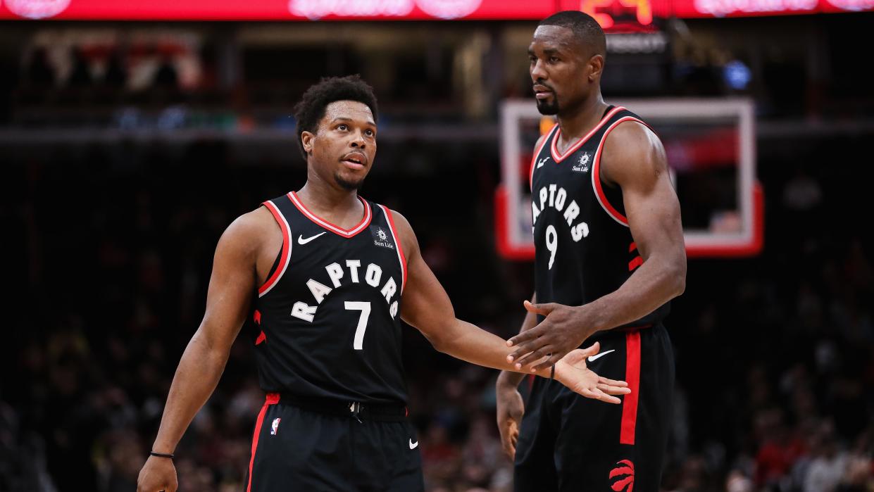CHICAGO, ILLINOIS - MARCH 30:  Kyle Lowry #7 and Serge Ibaka #9 of the Toronto Raptors celebrate in the first quarter against the Chicago Bulls at the United Center on March 30, 2019 in Chicago, Illinois. NOTE TO USER: User expressly acknowledges and agrees that, by downloading and or using this photograph, User is consenting to the terms and conditions of the Getty Images License Agreement. (Photo by Dylan Buell/Getty Images)