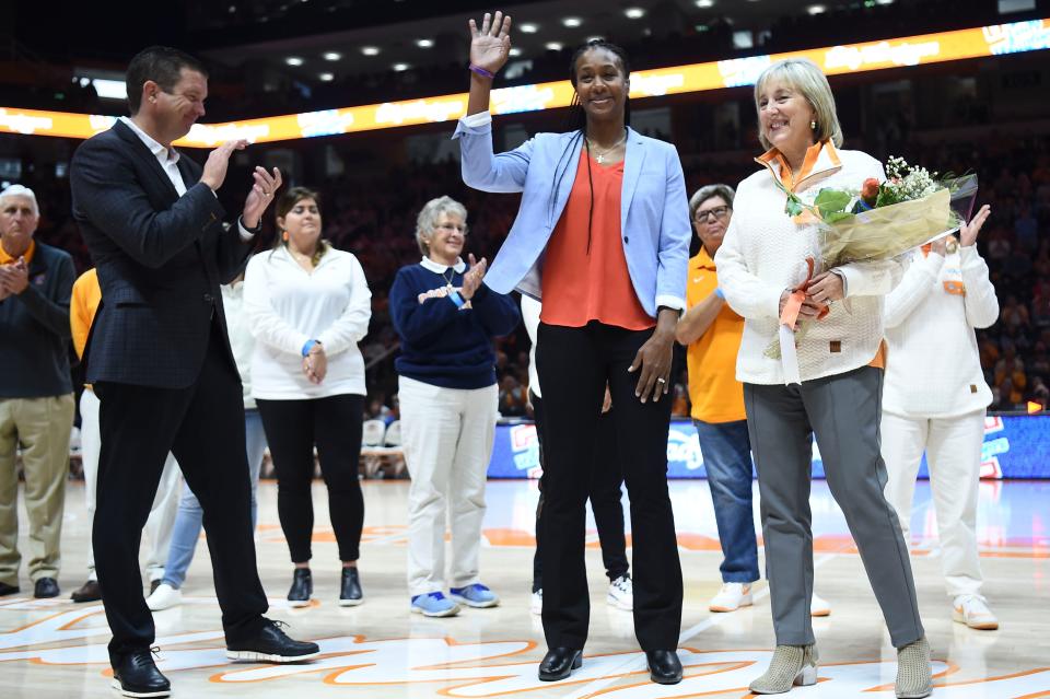 Tamika Catchings waves to fans while flanked by Tennessee Athletic Director Danny White and Chancellor Donde Plowman while she is recognized during the half in the NCAA women's basketball game between the Tennessee Lady Vols and Texas Longhorns in Knoxville, Tenn. on Sunday, November 21, 2021.