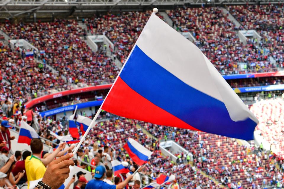 Russia supporters wave flags prior to the Russia 2018 World Cup round of 16 football match between Spain and Russia at the Luzhniki Stadium in Moscow on July 1, 2018. (Getty Images)