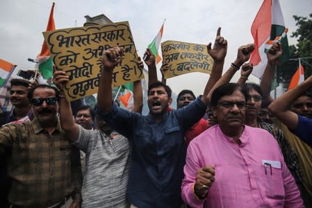 People shout slogans as they celebrate after the government scrapped the special status of Kashmir, in Ahmedabad