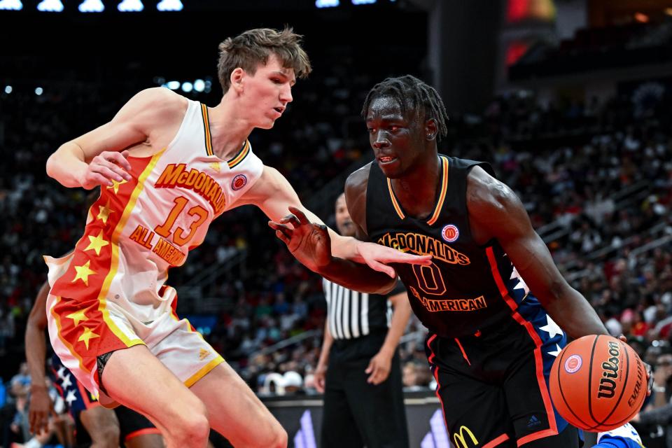 Omaha Biliew, right, drives to the basket as Matas Buzelis defends during the McDonald's All-American game.