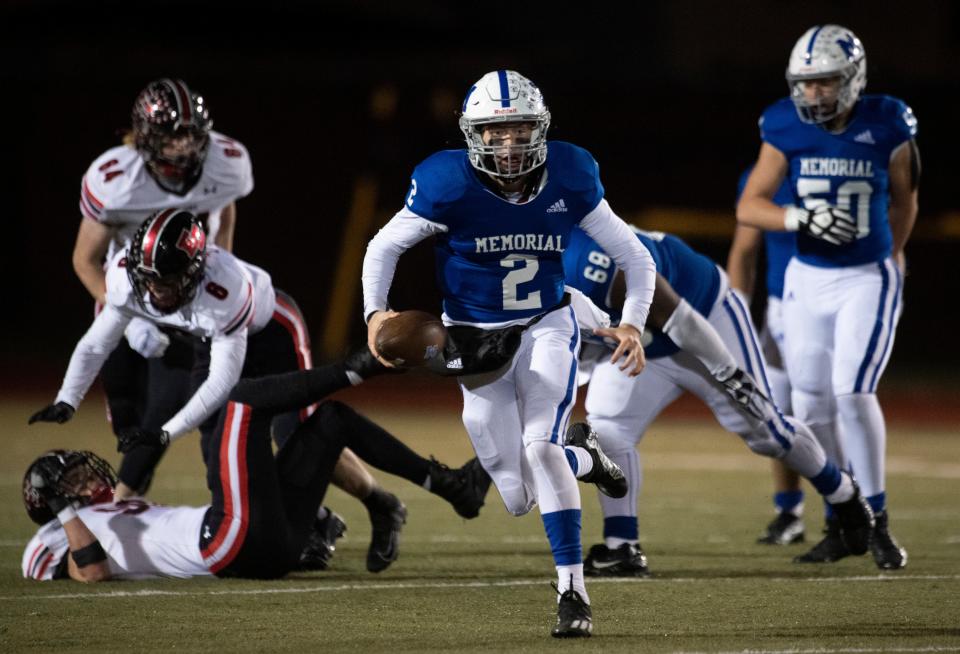 Memorial’s Matthew Fisher (2) carries the ball as the Memorial Tigers play the East Central Trojans in the IHSAA 4A regional #12 at Enlow Field in Evansville, Ind., Friday evening, Nov. 11, 2022. 