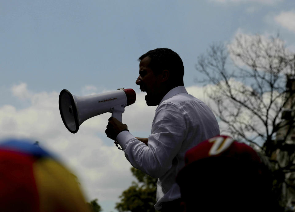 The leader of Venezuela's National Assembly Juan Guaido, who declared himself the country's interim president, uses a megaphone to speak to supporters during a rally against the government of President Nicolas Maduro, in Caracas, Venezuela, Saturday, March 9, 2019. (AP Photo/Fernando Llano)