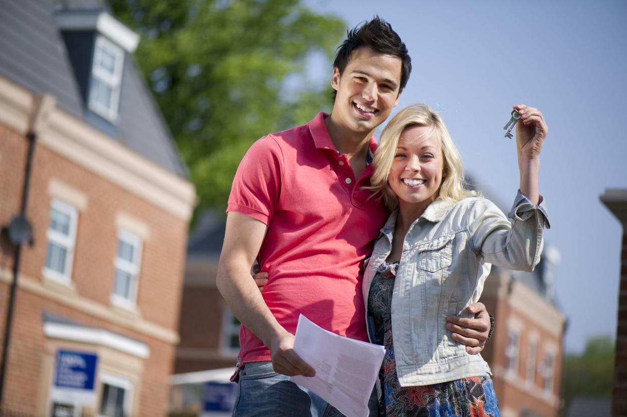 young couple celebrate getting the keys to their new house