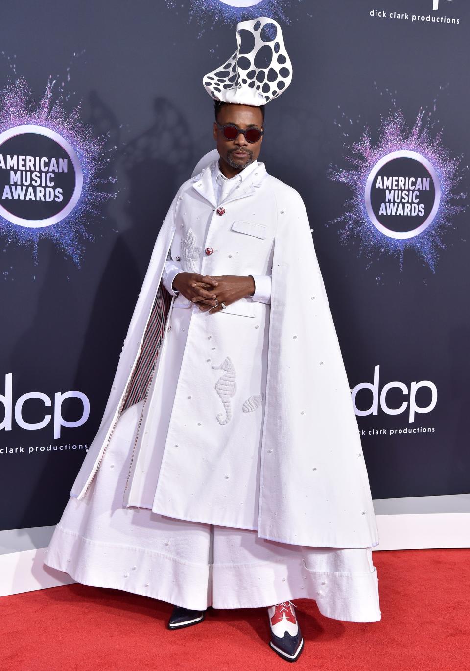 Billy Porter at the 2019 American Music Awards in white gown and abstract headpiece