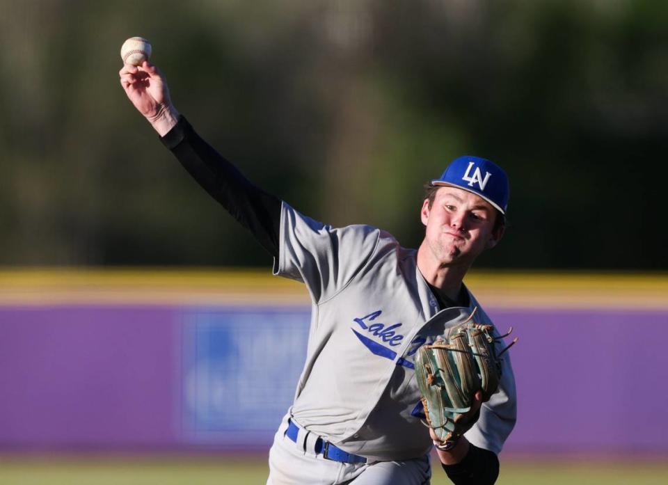 Lake Norman Wildcats Caden Beaver pitches against the Cox Mill Chargers at Cox Mill High School in Concord, N.C., on Friday, April 12, 2024.