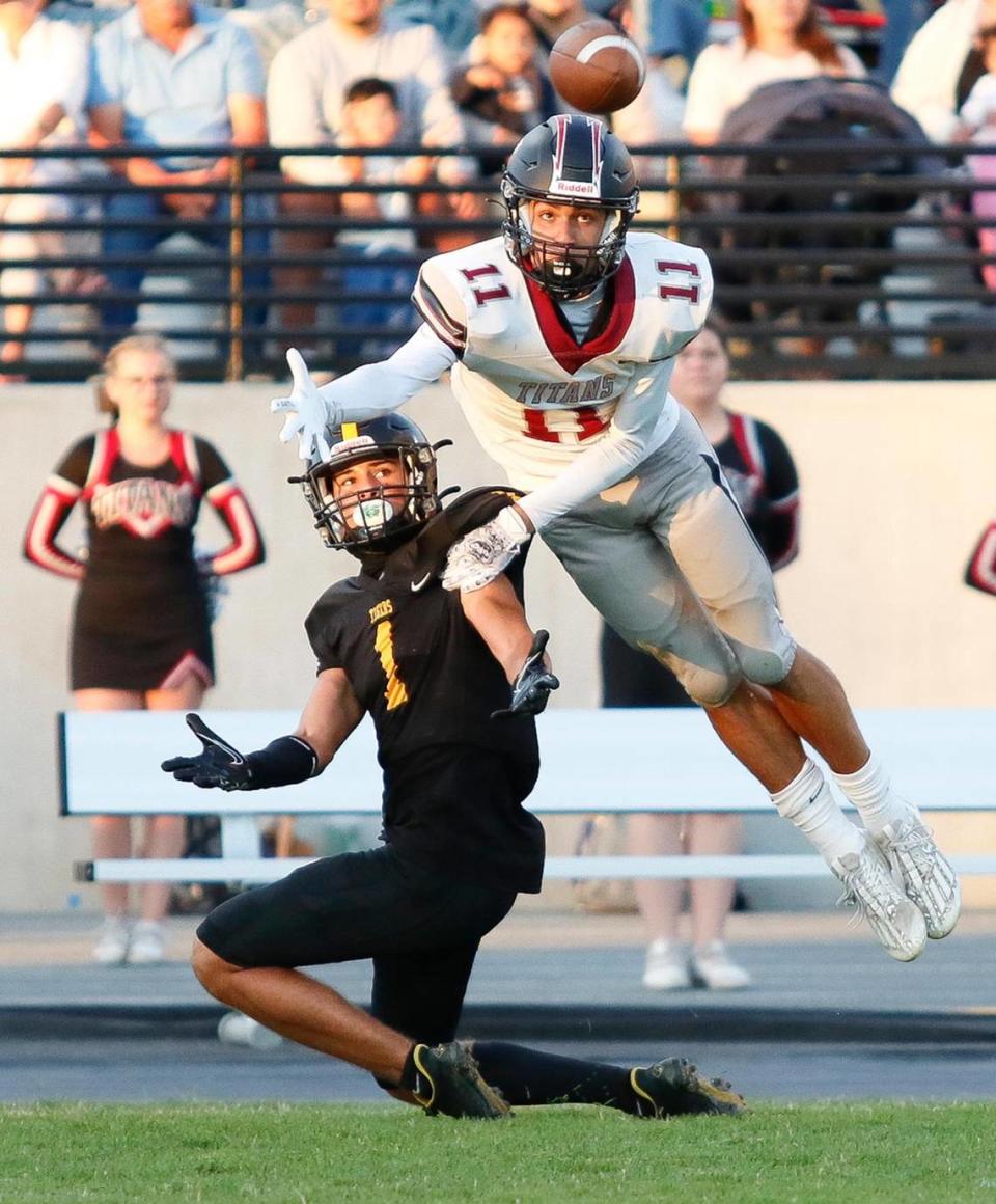 San Luis Obispo High Tigers beat the Nipomo Titans, 38-7 in a nonleague game at San Luis Obispo High School’s Holt Field stadium, August 18, 2023. Nipomo’s wide receiver Joseph Canales (11) looks to catch the pass and just misses it. SLO Tiger’s Fredo Figueroa is ready to intercept but misses too.