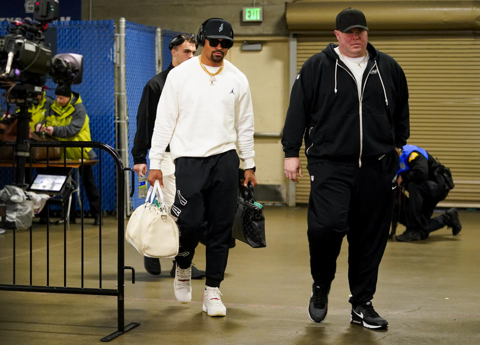 Philadelphia Eagles quarterback Jalen Hurts, left, arrives with chief security officer Dom DiSandro, right, before an NFL football game against the Seattle Seahawks, Monday, Dec. 18, 2023, in Seattle. (AP Photo/Lindsey Wasson)