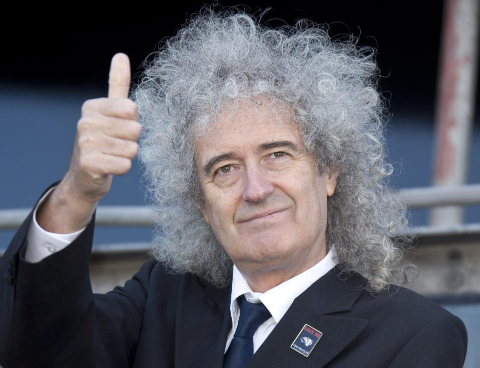 British musician Brian May gestures as he stands on a cherry picker to launch the national Team Badger campaign, in front of a giant billboard, on Cromwell road, west London, Wednesday, Sept. 19, 2012. A rock star is facing off against British farmers, over badgers. The government has issued licenses for the country's first badger cull, and soon snipers will be roaming in search of the animals. But Queen guitarist Brian May is leading a band of badger defenders vowing to stop them. (AP Photo/Joel Ryan)