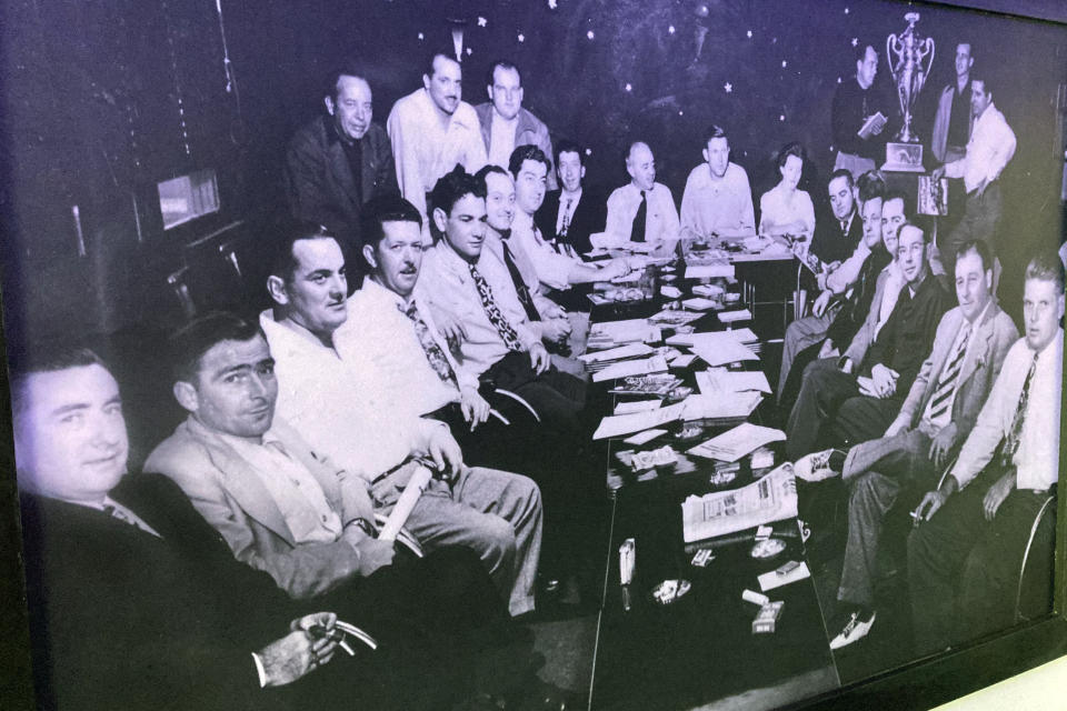 Bill France, founder of NASCAR, back center, and other founding members are seen in this historical photo displayed in the lobby of the Streamline Hotel in Daytona Beach, Fla., on Friday, Jan 27, 2023. The Streamline Hotel, which opened in 1941 and was recognized as the birthplace of NASCAR because of its history of hosting meetings between drivers and officials, has once again become an icon near the famous beach. (AP Photo/Mark Long)