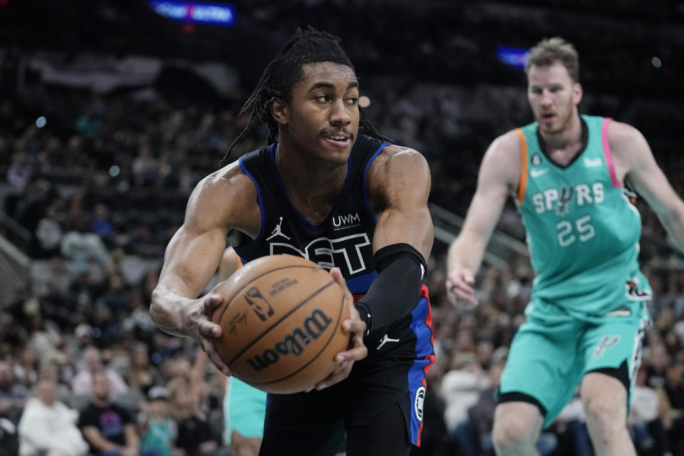 Detroit Pistons guard Jaden Ivey (23) grabs the ball in front of San Antonio Spurs center Jakob Poeltl (25) during the second half of an NBA basketball game in San Antonio, Friday, Jan. 6, 2023. (AP Photo/Eric Gay)