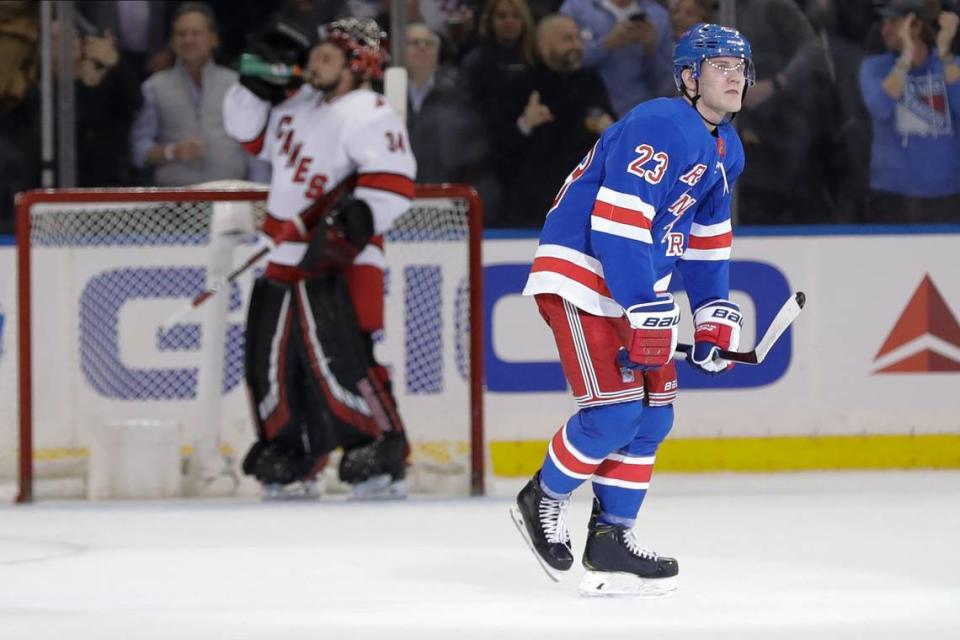 New York Rangers’ Adam Fox (23) skates past Carolina Hurricanes goaltender Petr Mrazek (34) after scoring a goal during the first period of an NHL hockey game Wednesday, Nov. 27, 2019, in New York. (AP Photo/Frank Franklin II)