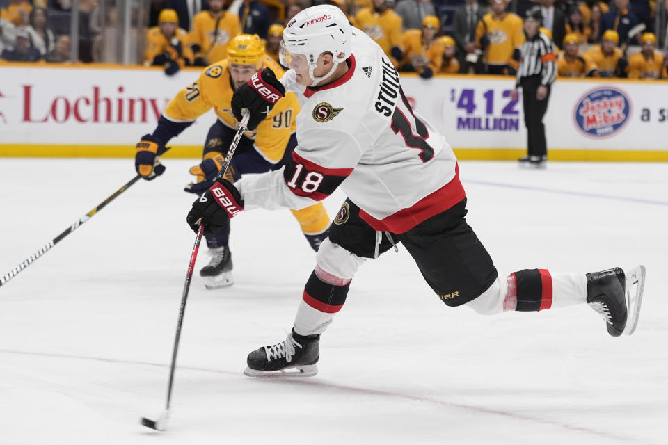 Ottawa Senators center Tim Stutzle (18) shoots the puck during the first period of an NHL hockey game against the Nashville Predators, Tuesday, Feb. 27, 2024, in Nashville, Tenn. (AP Photo/George Walker IV)