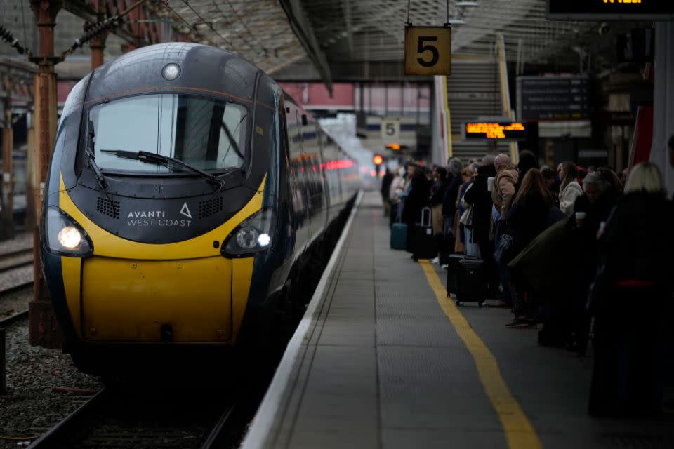 CREWE, ENGLAND – DECEMBER 01: Passengers wait to board an Avanti West Coast mainline train at Crewe Station on December 01, 2022 in Crewe, England. The Rail, Maritime and Transport workers union (RMT) said its members will strike on eight days – December 13, 14, 16 and 17, and January 3, 4, 6 and 7 – the latest episode in a dispute over pay and working practices. (Photo by Christopher Furlong/Getty Images)