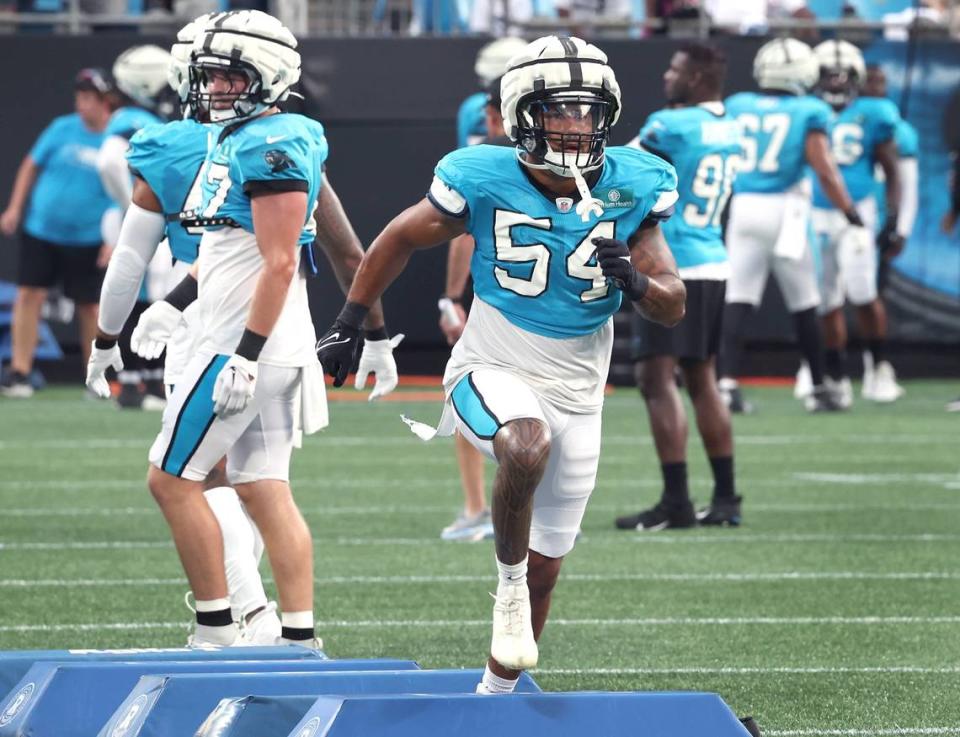 Carolina Panthers linebacker Kamu Grugier-Hill jumps over pads as he runs through a drill during the team’s Fan Fest practice at Bank of America Stadium on Wednesday, August 2, 2023.