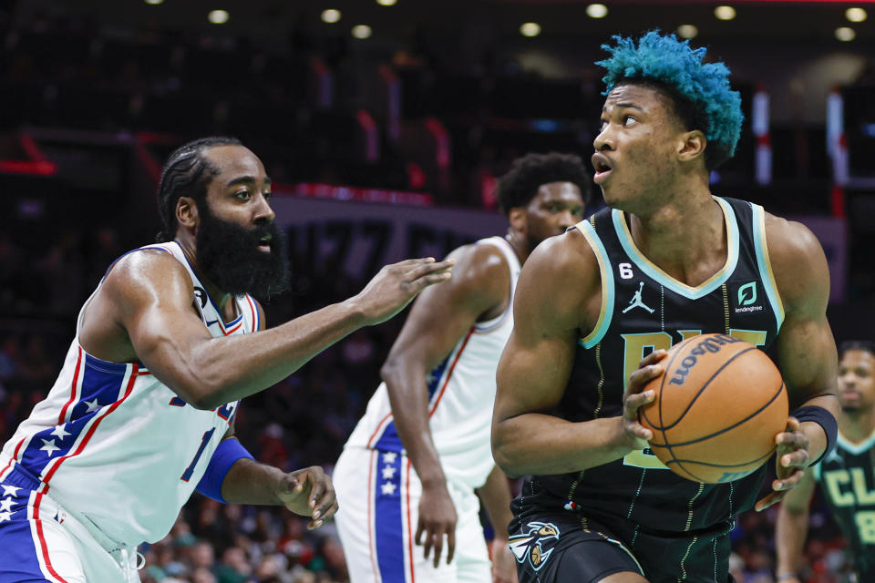 Charlotte Hornets forward Kai Jones, right, looks to shoot against Philadelphia 76ers guard James Harden (1) during the first half of an NBA basketball game in Charlotte, N.C., Friday, March 17, 2023. (AP Photo/Nell Redmond)