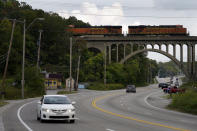 Cars travel under a landmark railroad viaduct on a stretch of Blue Parkway Tuesday, Sept. 22, 2020, in Kansas City, Mo. The stretch of road, along with parts of two other streets, would be renamed to honor Rev. Martin Luther King Jr. under a city proposal coming in the wake of failed effort to honor King last year. (AP Photo/Charlie Riedel)