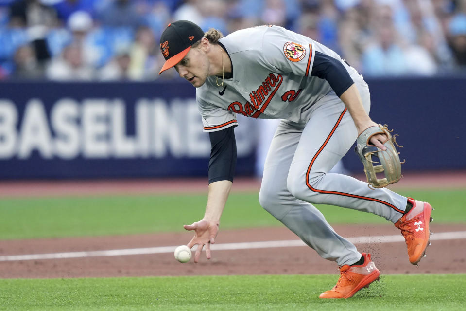 Baltimore Orioles third baseman Gunnar Henderson picks up the ball but his throw to first base is not in time to get out Toronto Blue Jays' Bo Bichette during first-inning baseball game action in Toronto, Monday, July 31, 2023. (Nathan Denette/The Canadian Press via AP)