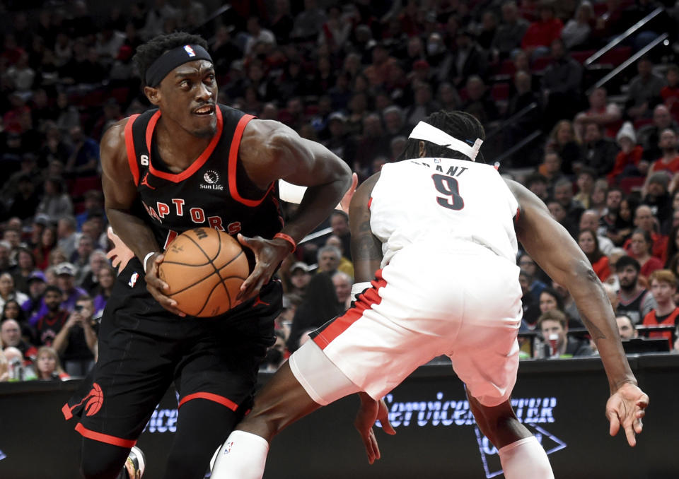 Toronto Raptors forward Pascal Siakam, left, drives to the basket against Portland Trail Blazers forward Jerami Grant during the first half of an NBA basketball game in Portland, Ore., Saturday, Jan. 28, 2023. (AP Photo/Steve Dykes)