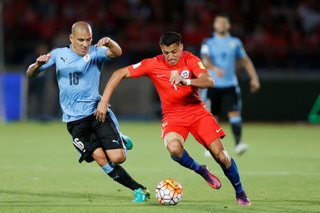 Chile's Alexis Sanchez and Uruguay Maximiliano Pereira. Chile v Uruguay - World Cup 2018 Qualifiers - Nacional stadium - Santiago, Chile. 15/11/16. REUTERS/Rodrigo Garrido