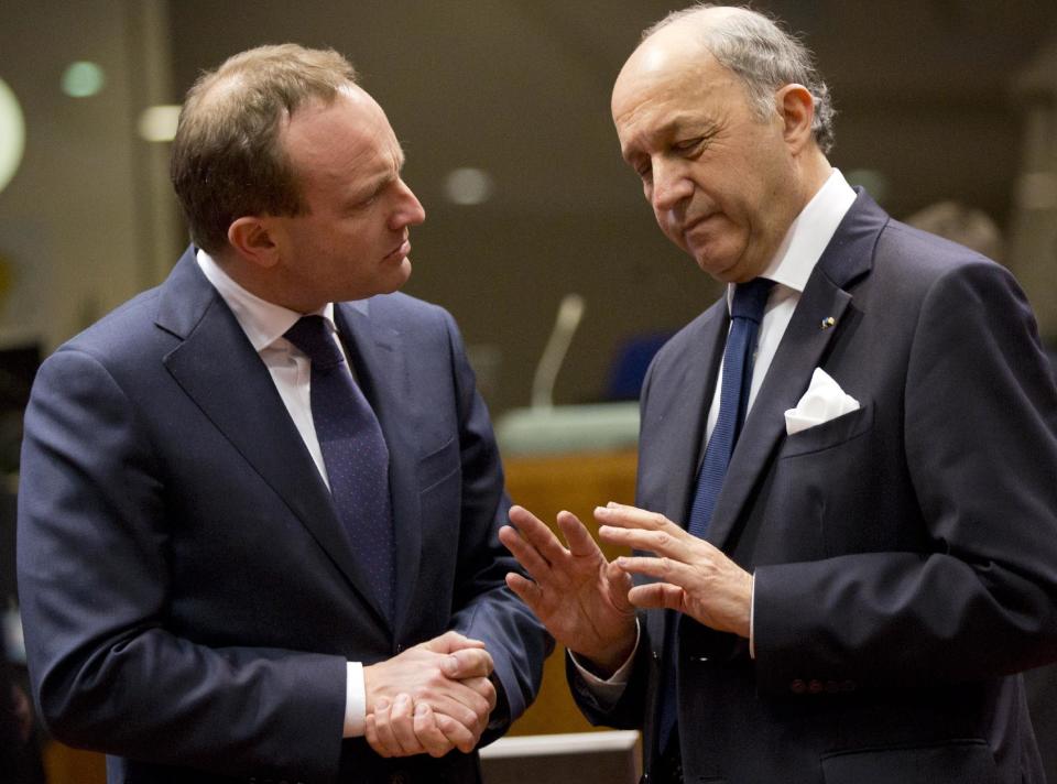 Danish Foreign Minister Martin Lidegaard, left, speaks with French Foreign Minister Laurent Fabius during an emergency meeting of EU foreign ministers at the EU Council building in Brussels on Monday, March 3, 2014. EU foreign ministers meet in emergency session on Monday to discuss the ongoing crisis in Ukraine. (AP Photo/Virginia Mayo)