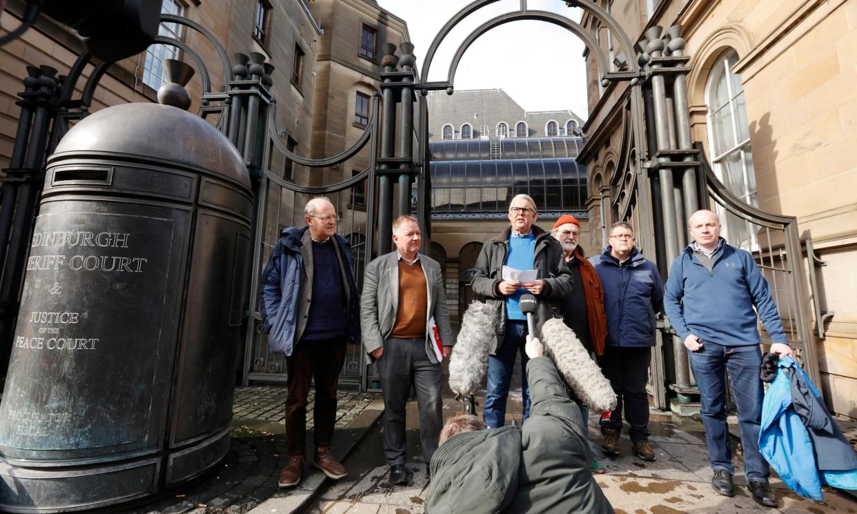 <span>Graeme Sneddon, centre, reads a statement alongside other victims of John Brownlee’s abuse outside Edinburgh sheriff court.</span><span>Photograph: Murdo MacLeod/The Guardian</span>