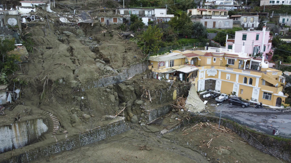 An aerial view of damaged houses after heavy rainfall triggered landslides that collapsed buildings and left as many as 12 people missing, in Casamicciola, on the southern Italian island of Ischia, Sunday, Nov. 27, 2022. (AP Photo/Salvatore Laporta)