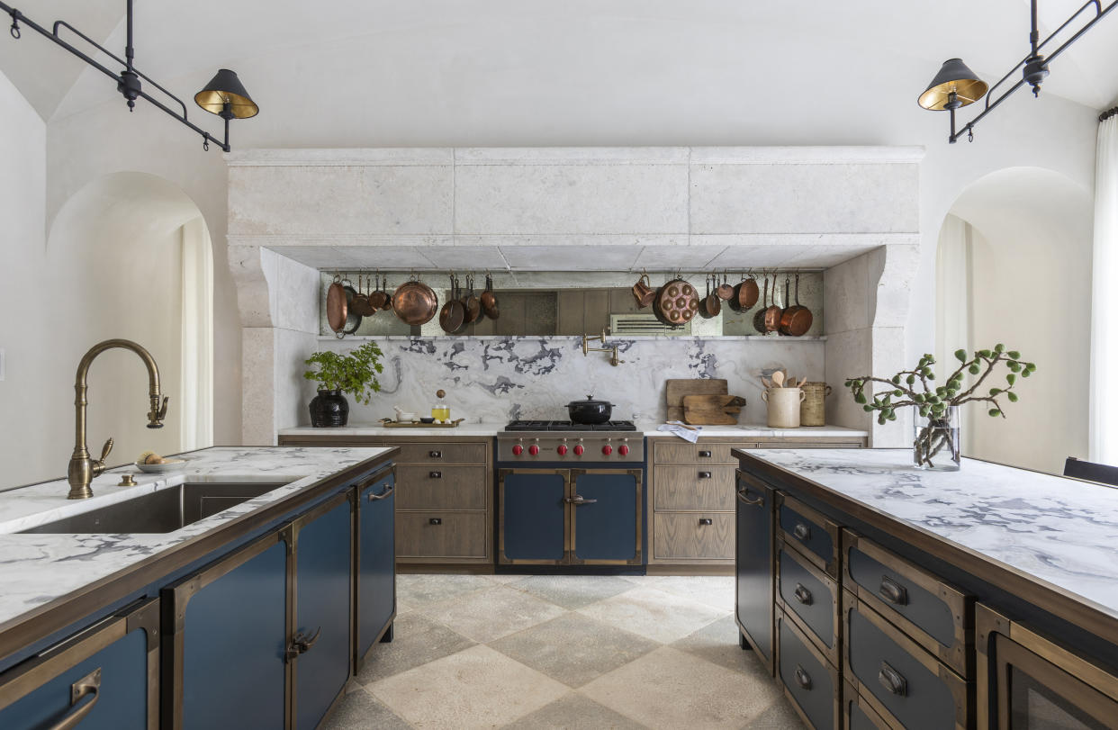  A kitchen with marble splashback that goes up the wall. 