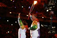 <p>The Olympic flame is lit jointly by former hockey goalie Vladislav Tretiak, who played from 1972 to 1984, and legendary figure skater Irina Rodnina.</p>