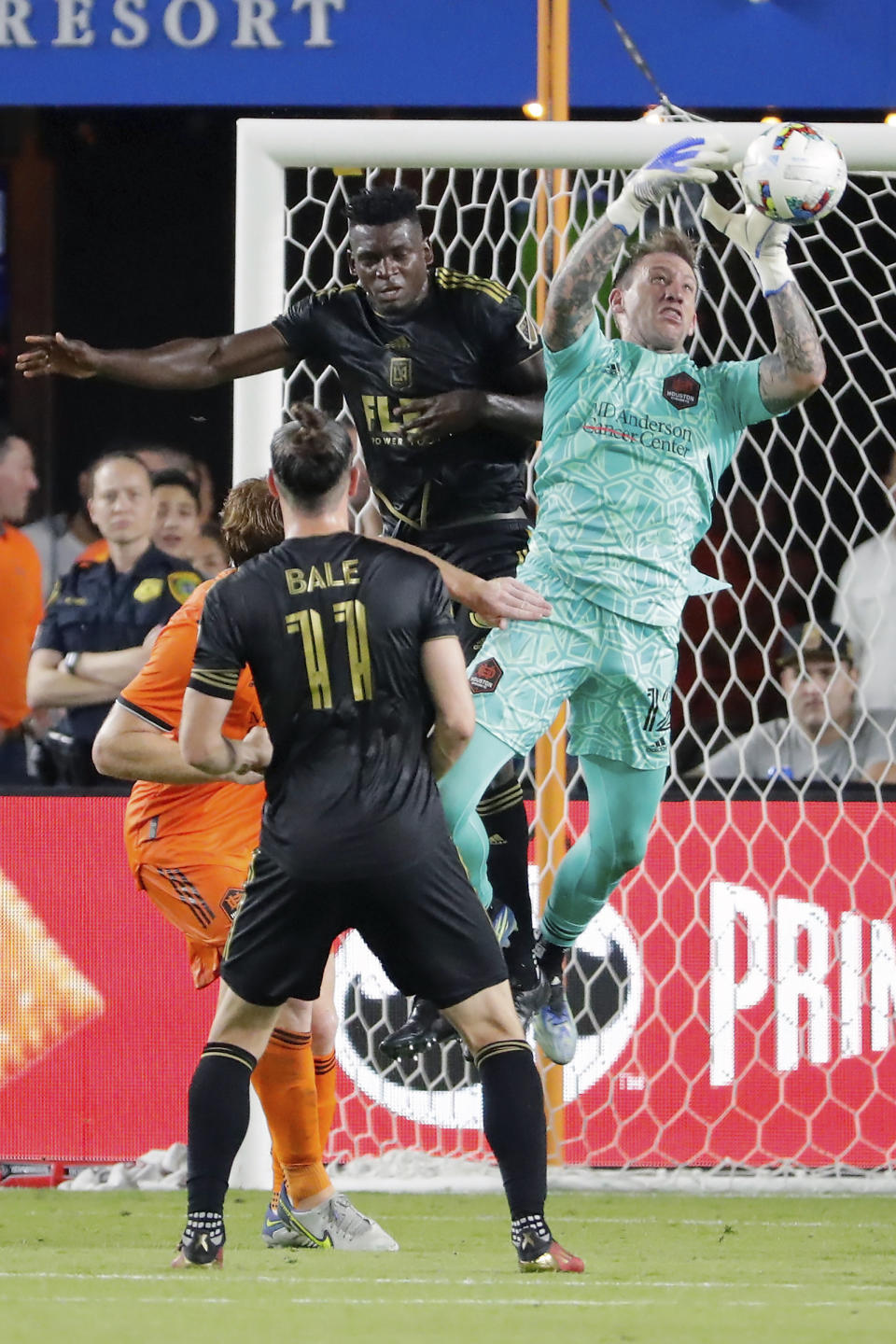 Houston Dynamo goalkeeper Steve Clark, top right, makes a save as he collides with Los Angeles FC defender Jesus Murillo, top left, as Gareth Bale (11) looks on during the second half of an MLS soccer match Wednesday, Aug. 31, 2022, in Houston. (AP Photo/Michael Wyke)